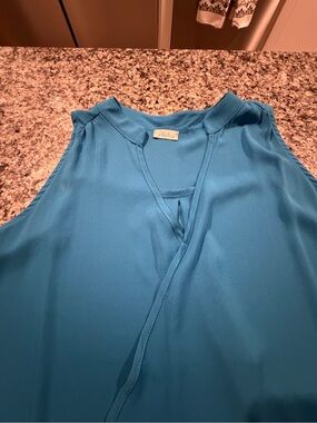 Abbeline sleeveless shirt size Small. V neck pleated shoulders.